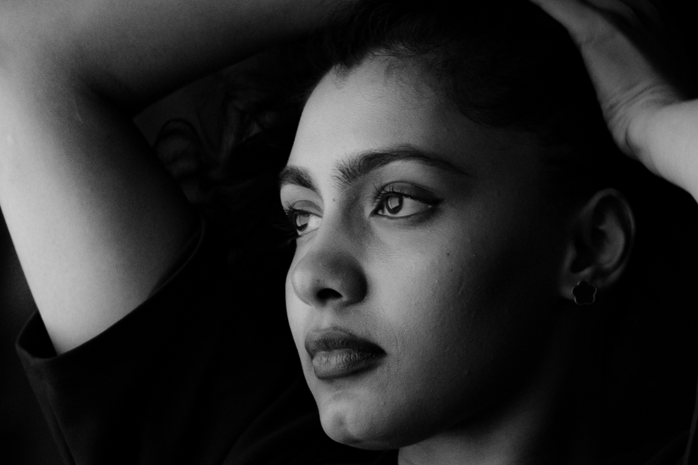 Extreme close-up black and white portrait, dramatic side light