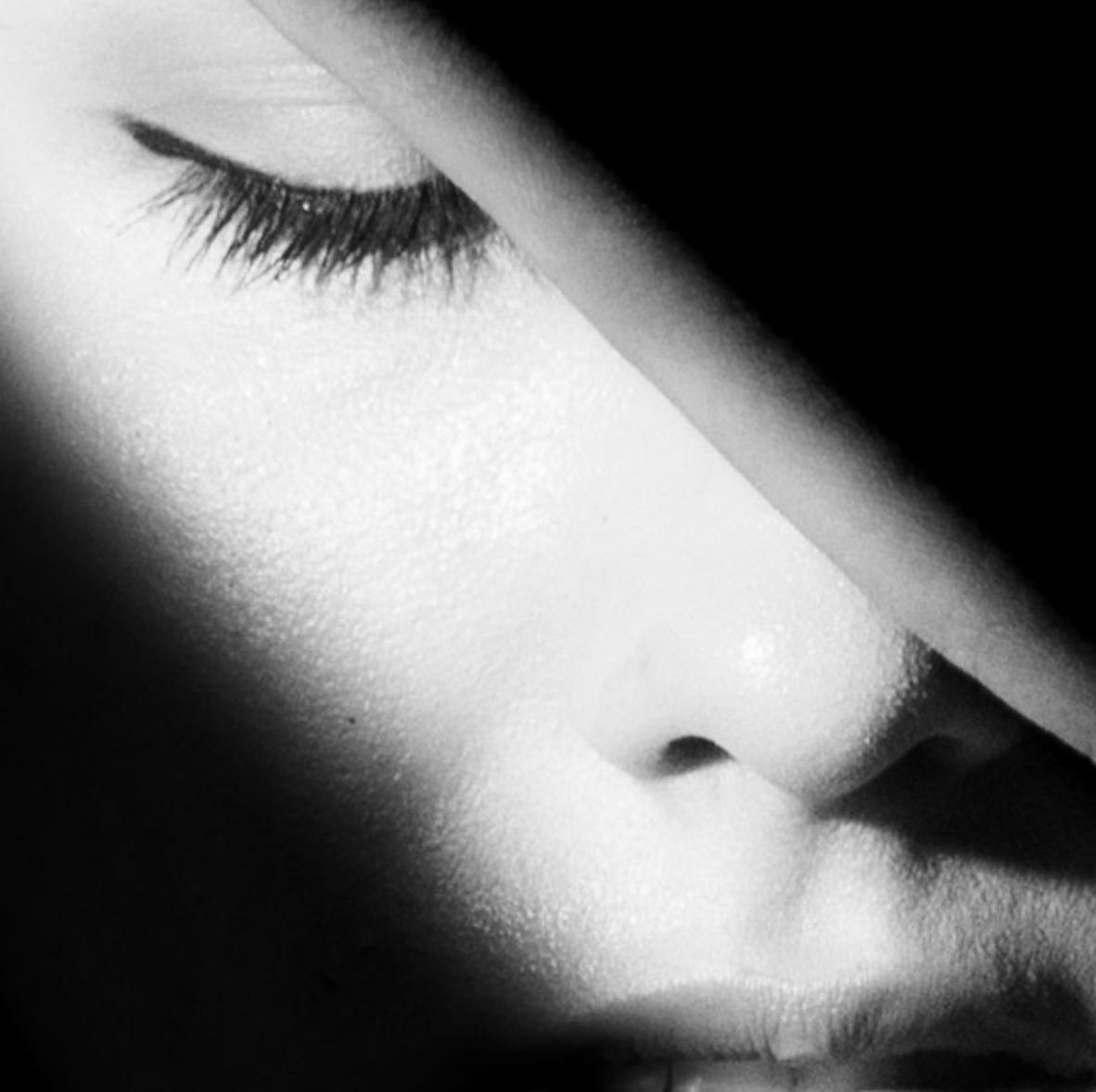 Extreme close-up black and white detail, dramatic side lighting