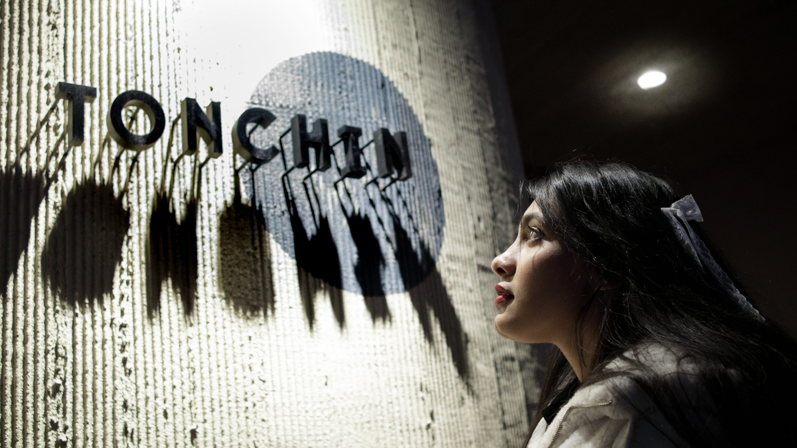 Candid portrait in a neon-lit night city setting